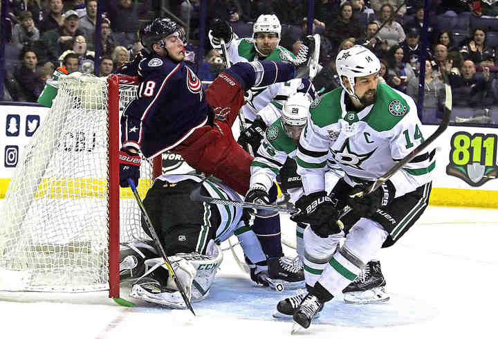 Columbus Blue Jackets center Pierre-Luc Dubois (18) is knocked into Dallas Stars goaltender Ben Bishop (30) in the first period of their game at Nationwide Arena in Columbus.  (Brooke LaValley / The Columbus Dispatch)